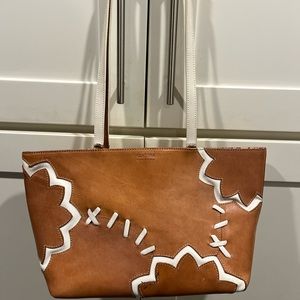 Claudia Firenze leather tote bag shaped in sports ball design.